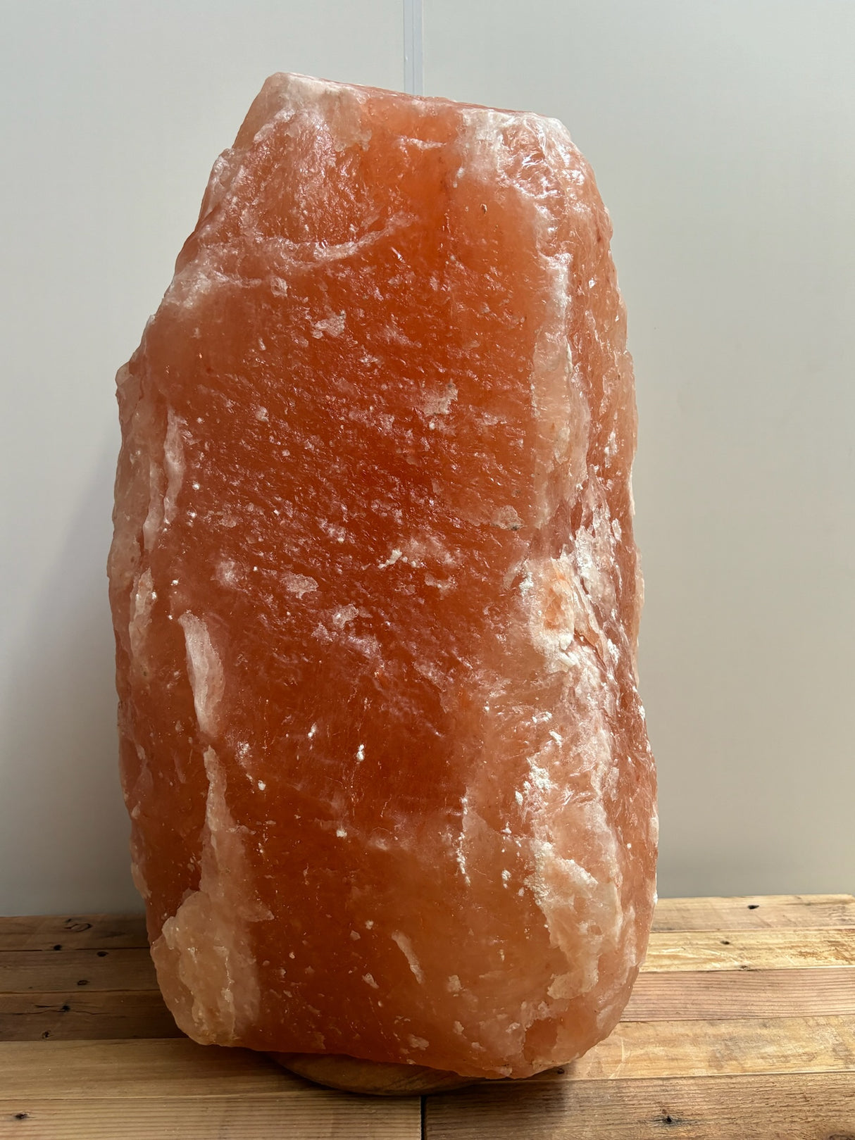 Himalaya XL zoutlamp 80–90 kg in zachte amberkleur op houten voet