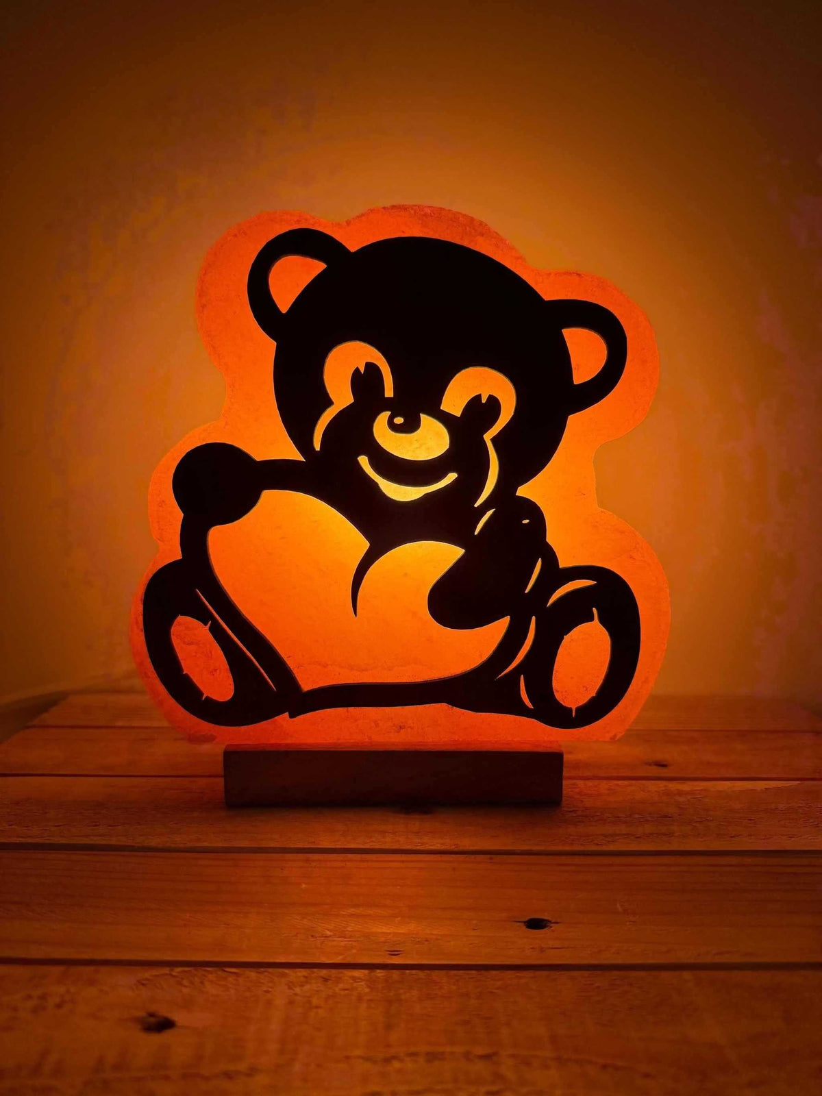 Himalaya zoutlamp in 3D-berenvorm met warm licht en houten voet